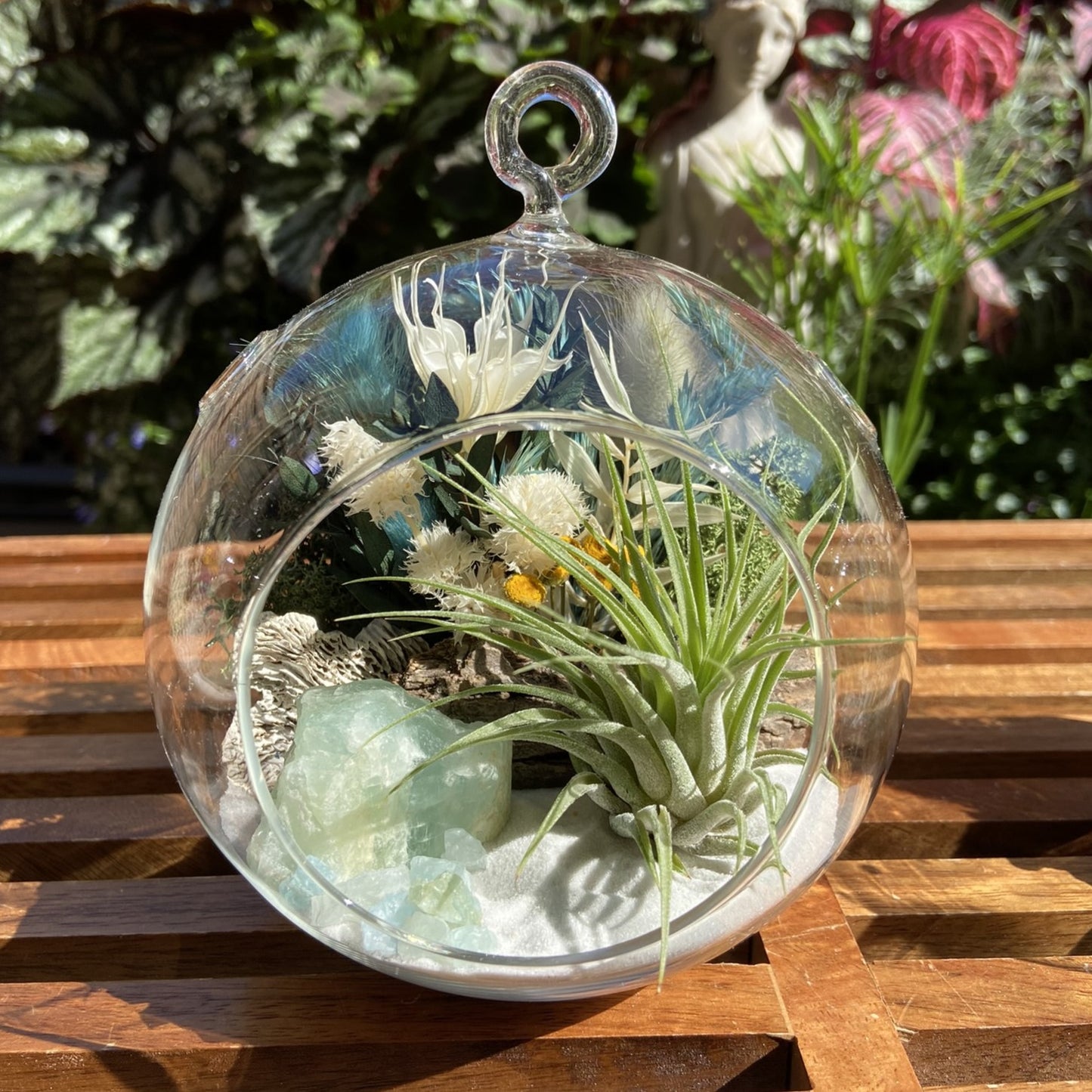 Glass bubble terrarium with airplant, dried flowers and aquamarine crystals