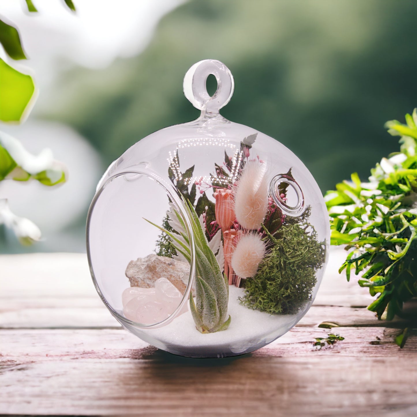 Glass bubble terrarium with airplant, dried flowers and rose quartz crystals