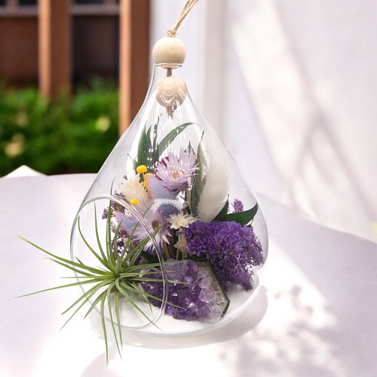 Teardrop airplant terrarium with amethyst crystal, dried flowers, wood and moss