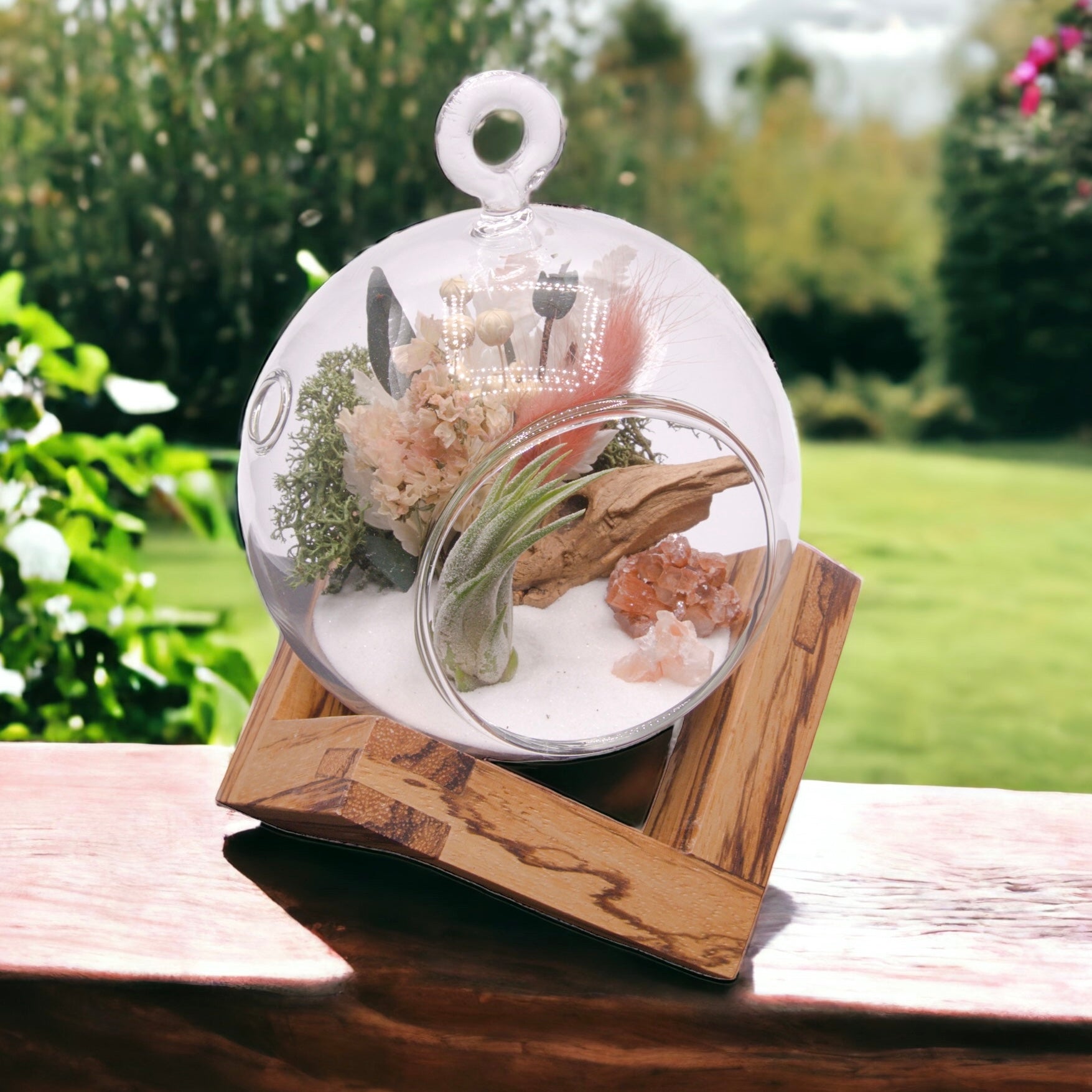 Glass bubble airplant terrarium with dried flowers and aragonite crystals