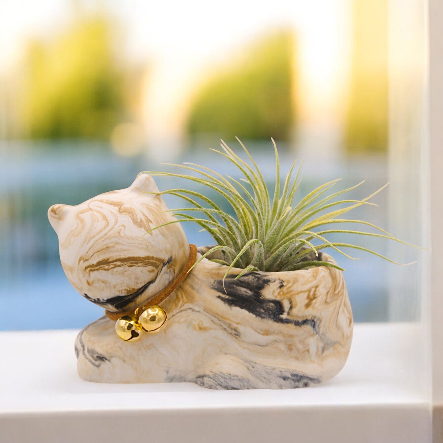 Handmade hydrostone pot in the shape of a cat with a faux-leather collar and bells