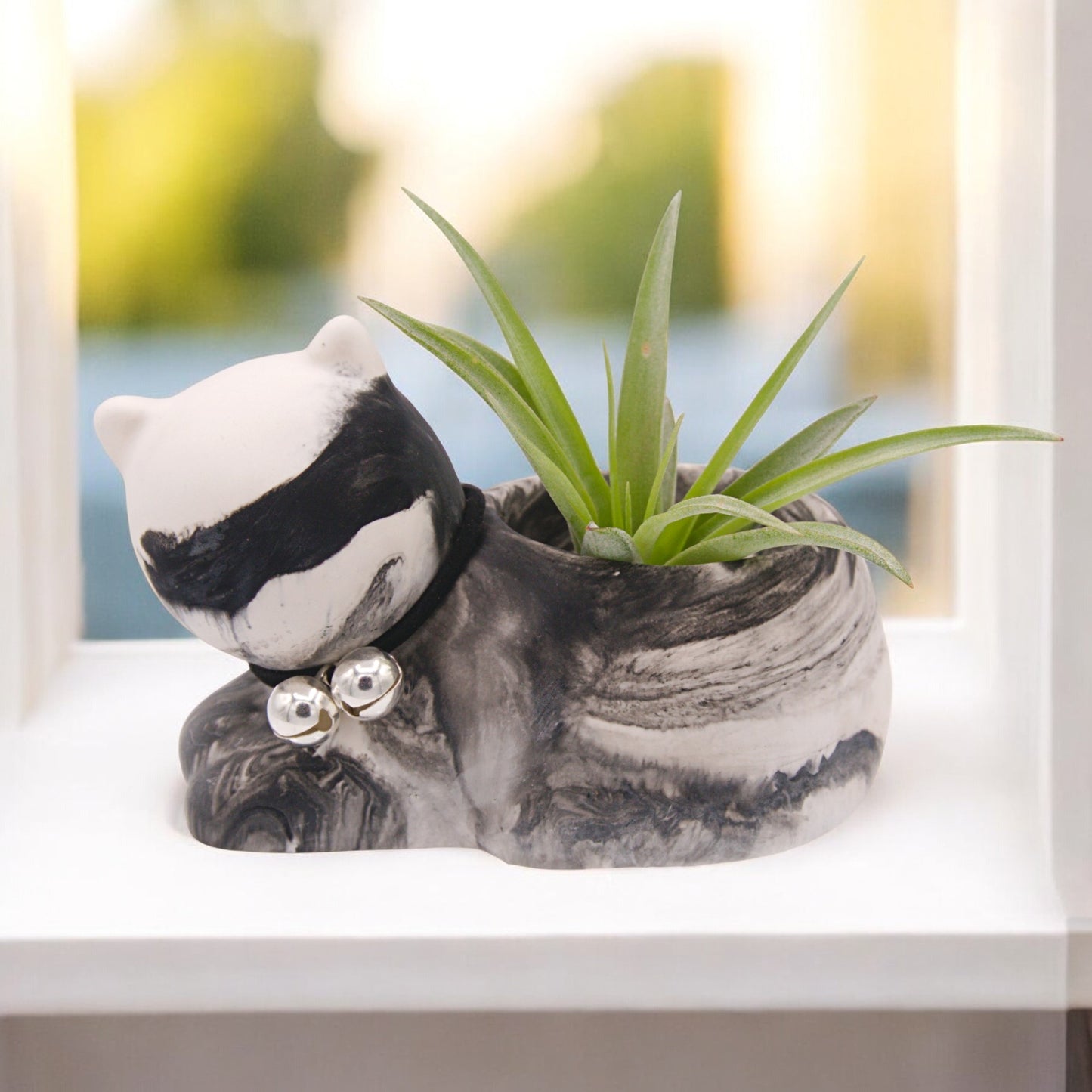 Handmade hydrostone pot in the shape of a cat with a faux-leather collar and bells