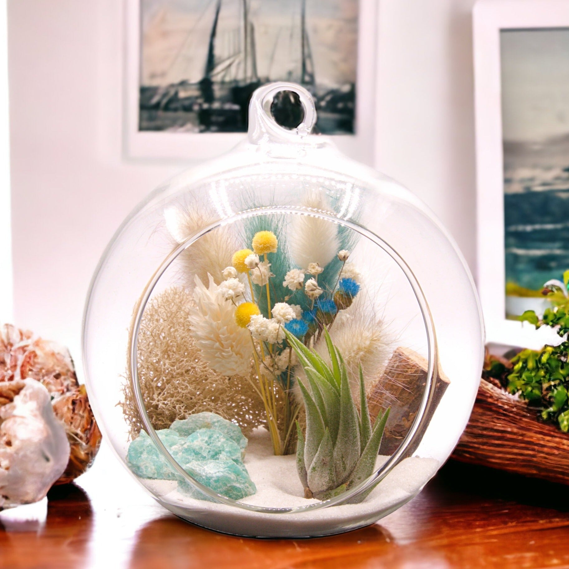 Glass bubble terrarium with an airplant, amazonite crystals and dried flowers