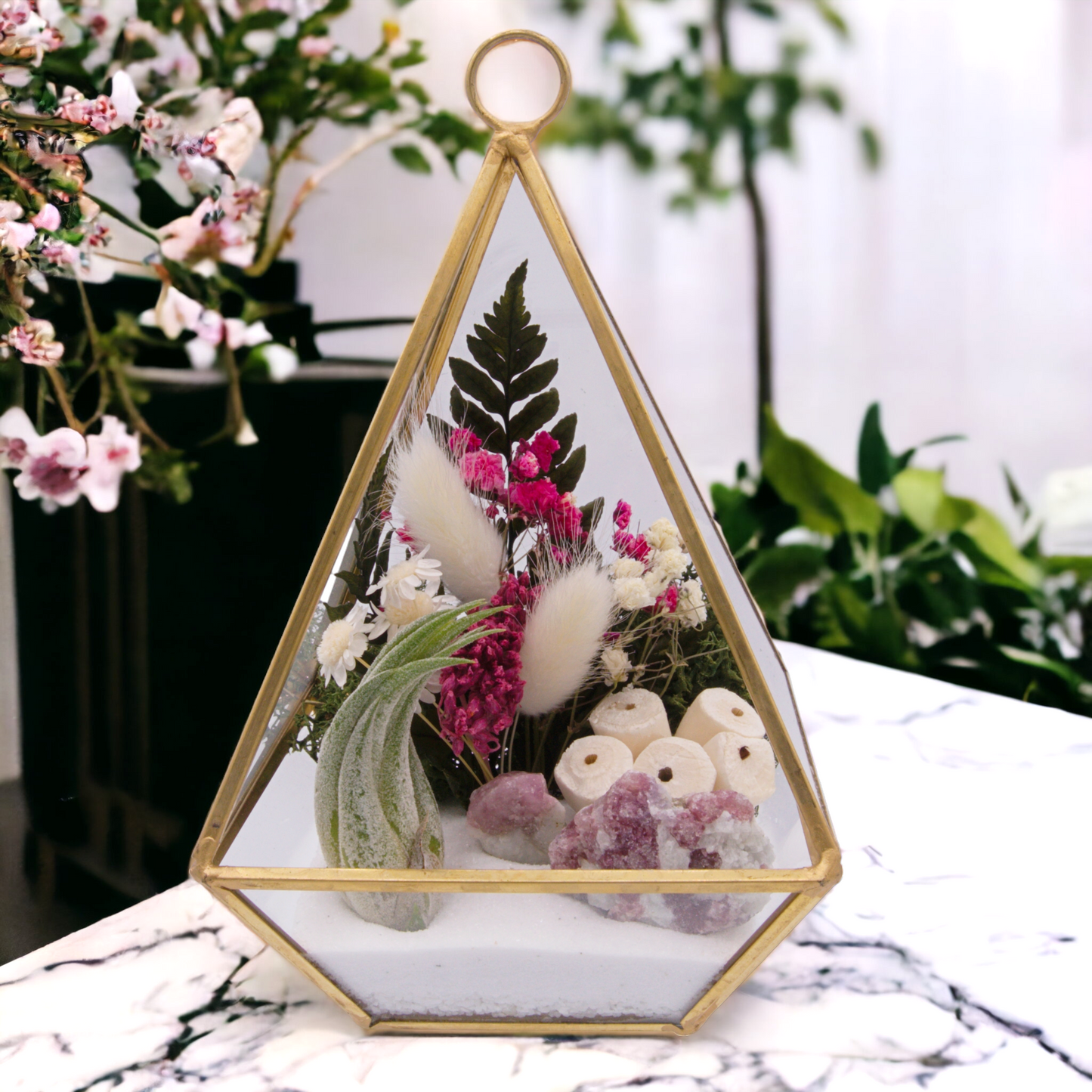 Victorian terrarium with sand, dried flowers, pink tourmaline crystals and an airplant