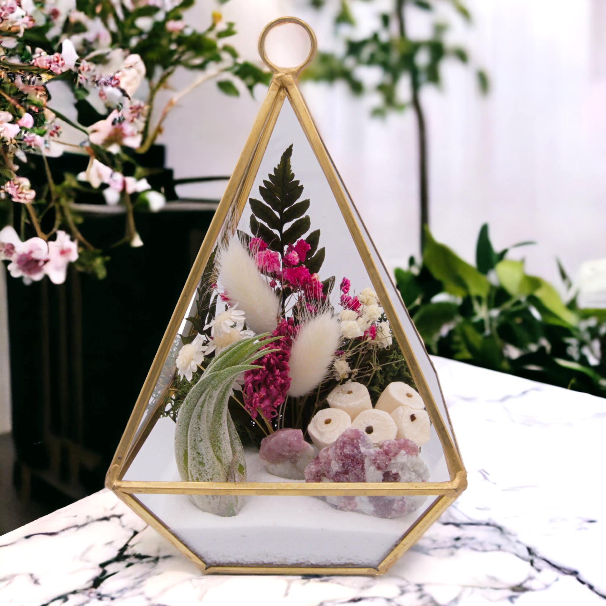 Victorian terrarium with sand, dried flowers, pink tourmaline crystals and an airplant