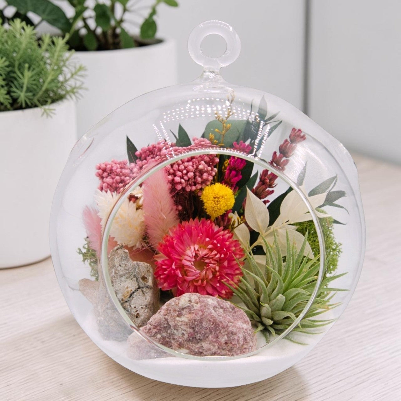 airplant terrarium with dried flowers, and a pink tourmaline crystal
