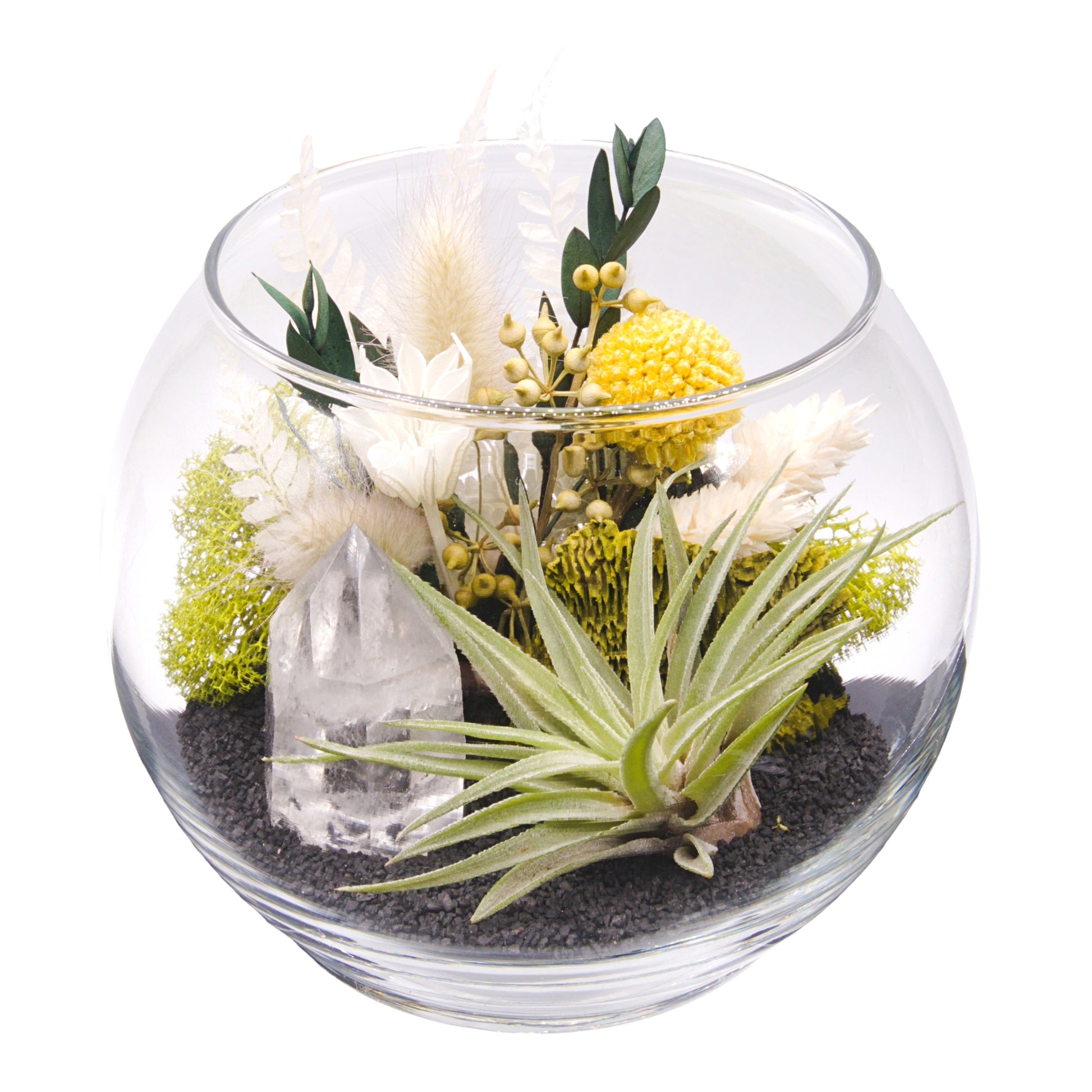 A glass bowl airplant terrarium with black sand, a bouquet of dried flowers, green moss, a dried mushroom and a crystal quartz tower.