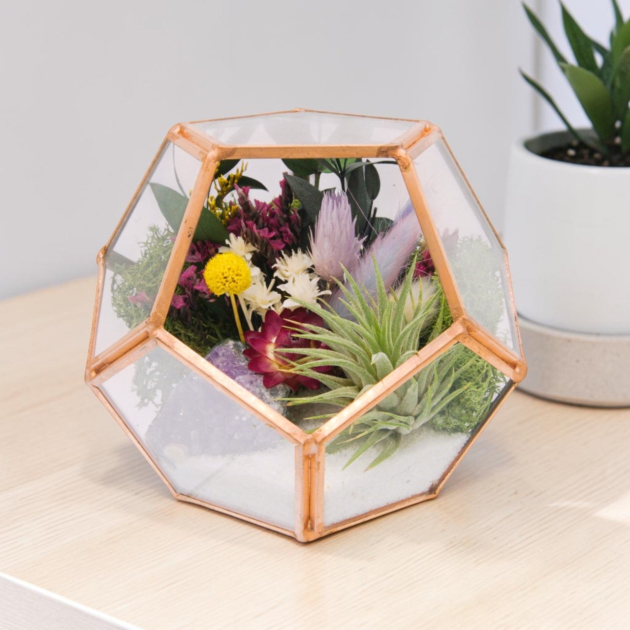 rose gold victorian style terrarium with dried flowers, an amethyst crystal and an airplant